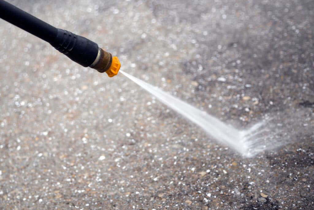 Pressure washing on pavement.